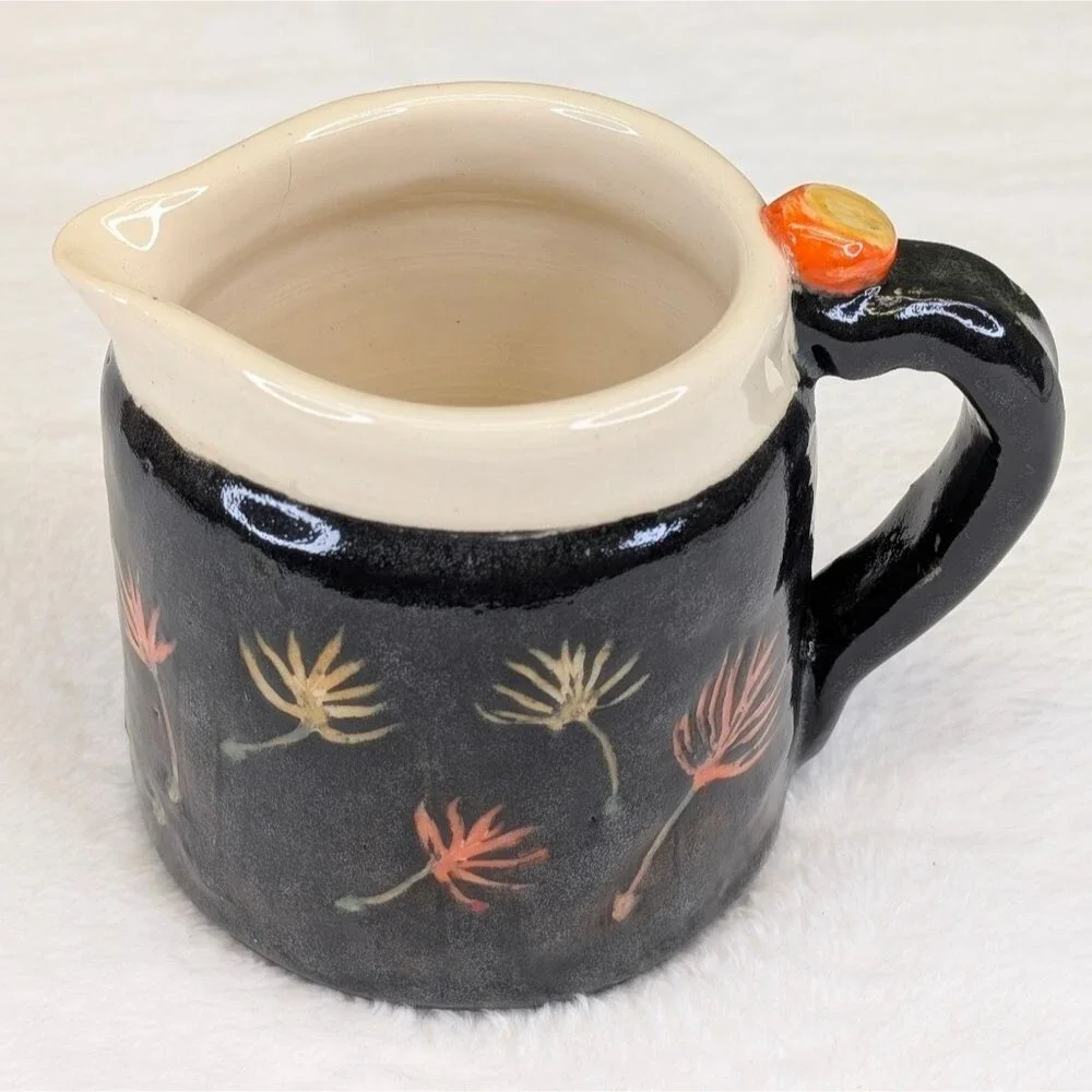 Handcrafted Black Ceramic Pitcher with Floral Design